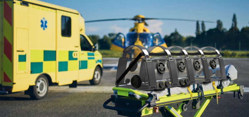 The image shows an ambulance and an air ambulance helicopter with a patient stretcher and the aeropod device attached.