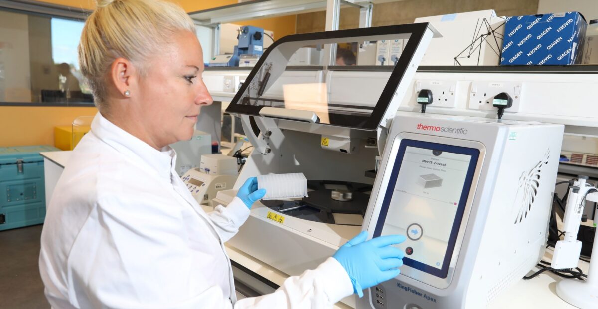 Scientist Dr Caroline Wilson operating a large piece of equipment in the innovation lab.