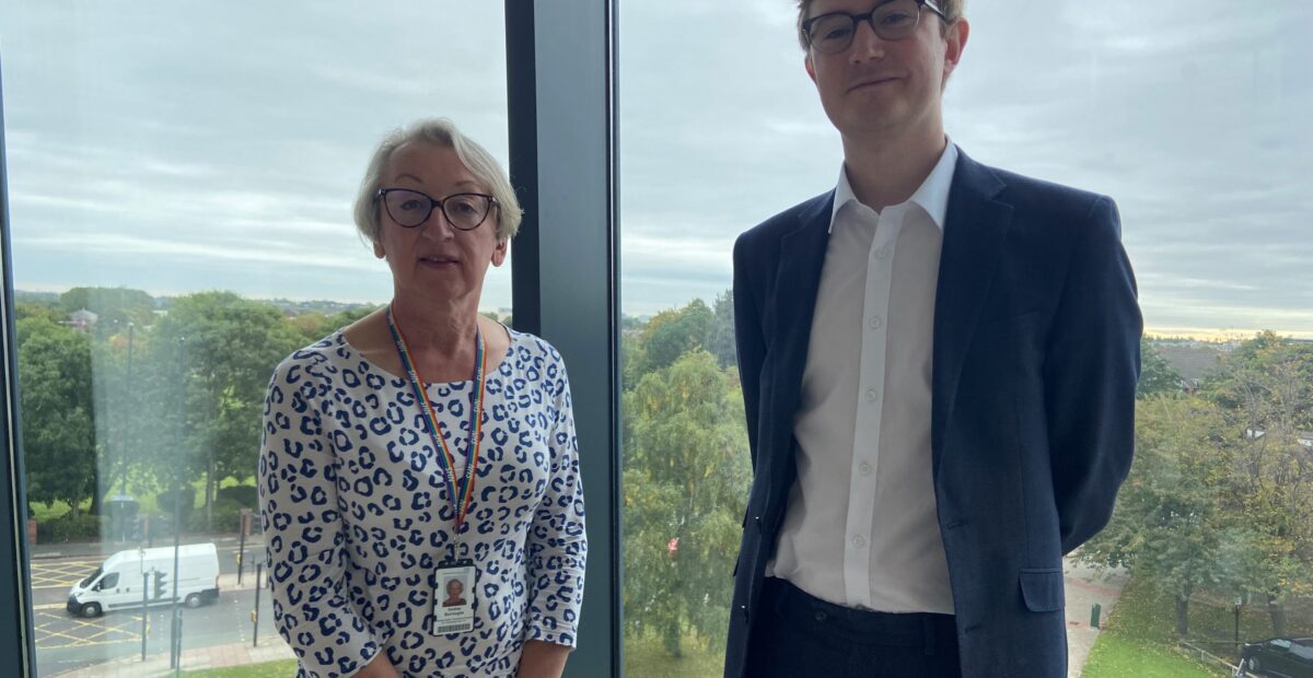 Andrea and Donal standing together by a window in Regent Point offices.