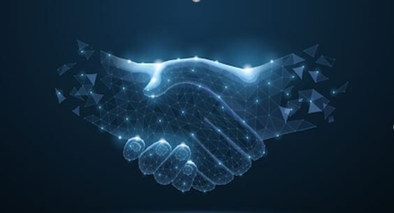 Close up shaking hands lit up with a dark background.