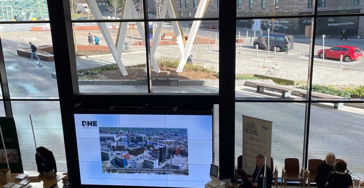 A view of the main lobby area of the Catalyst with a giant screen.