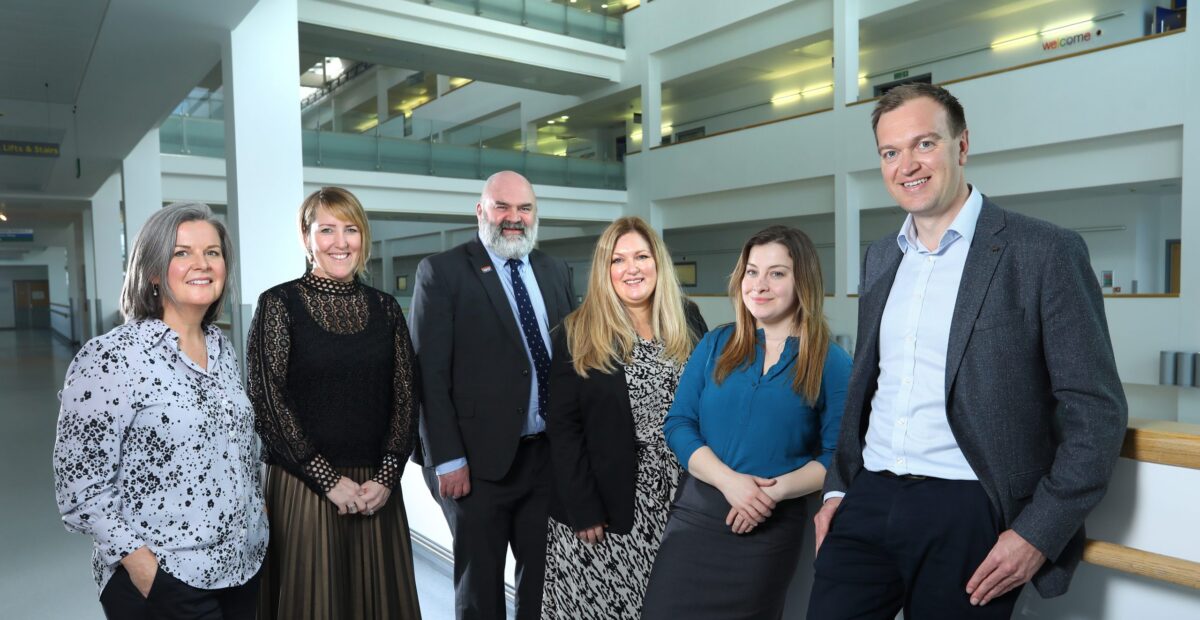 The commercial enterprise team stand in the atrium of the Royal Victoria Infirmary.