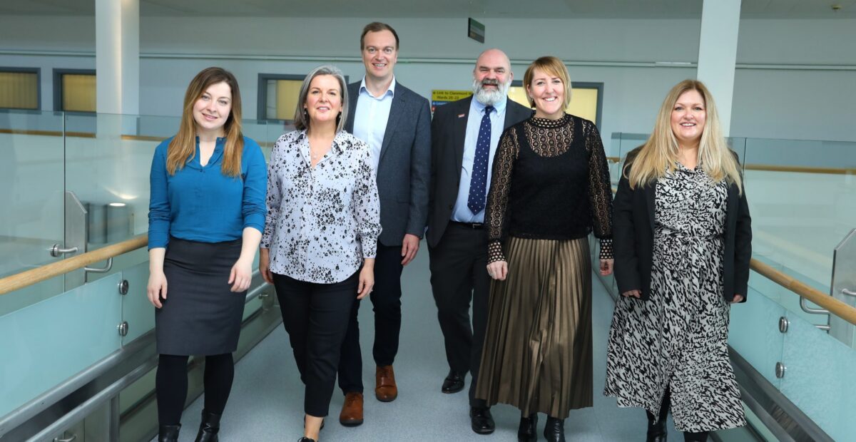 The commercial enterprise team standing in a hospital.