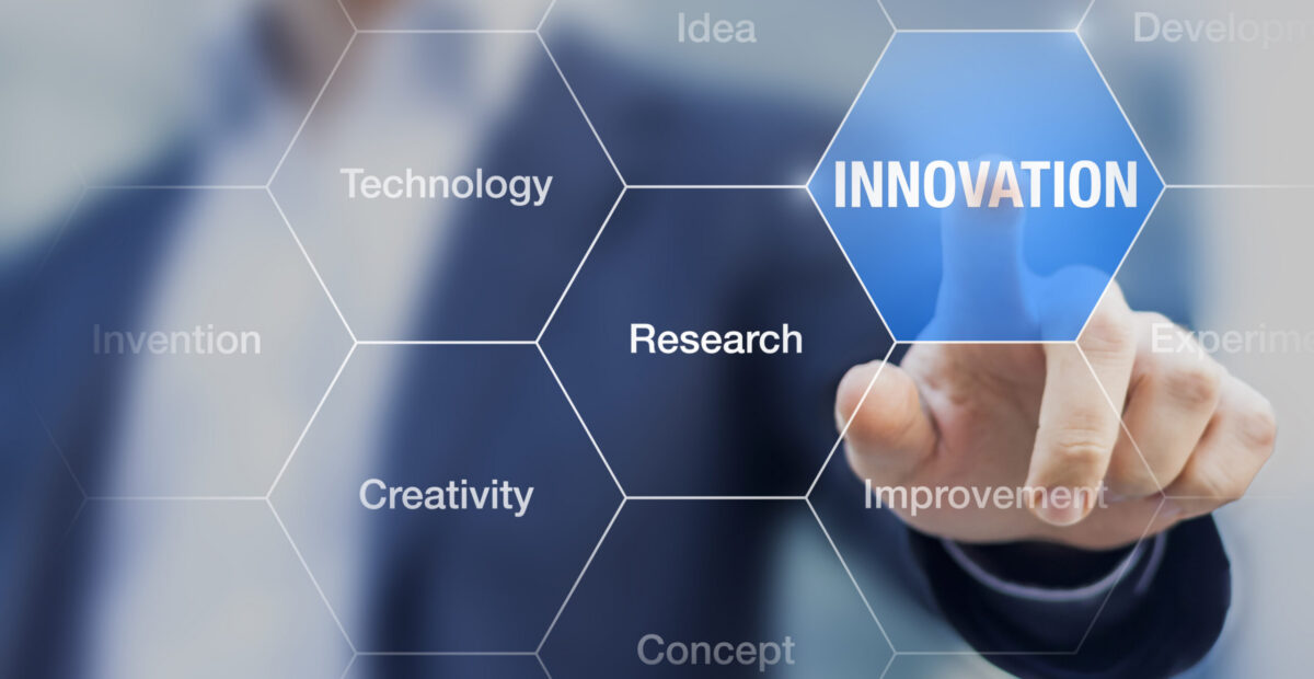 A graphic with lots of hexagons identifying innovation, with a finger pressing it.