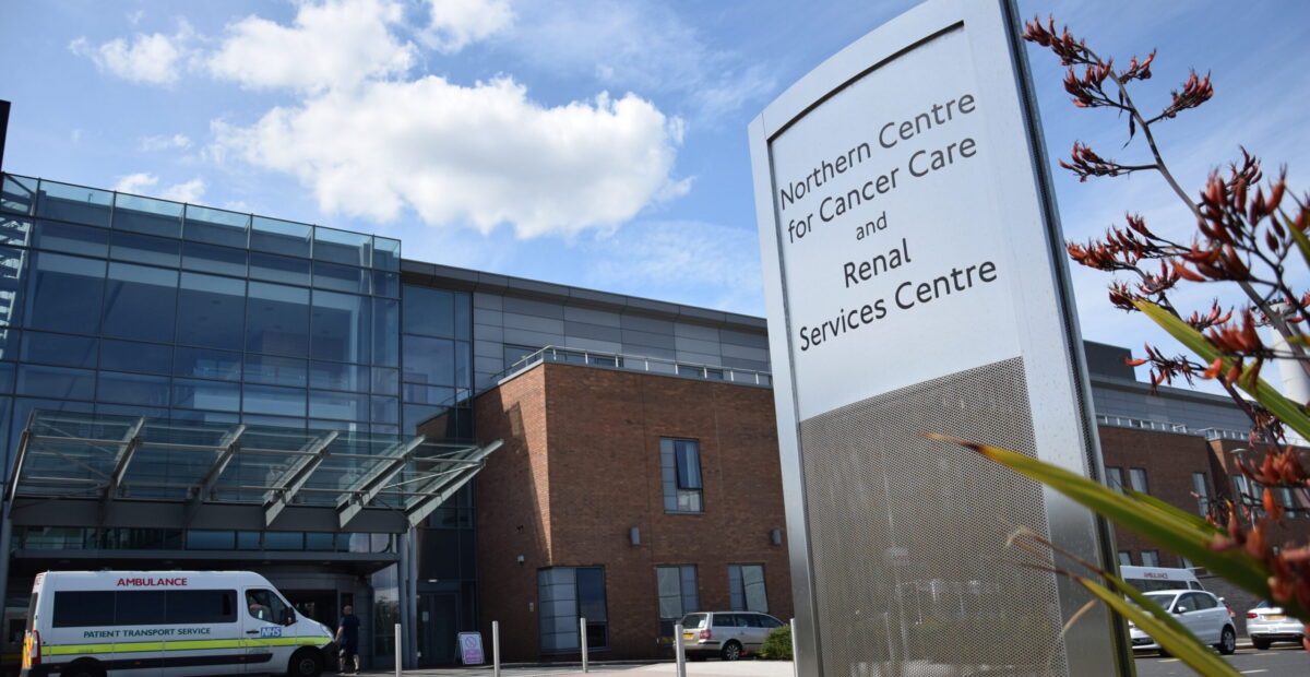 NCCC main entrance and sign with a patient transport ambulance situated outside the entrance.