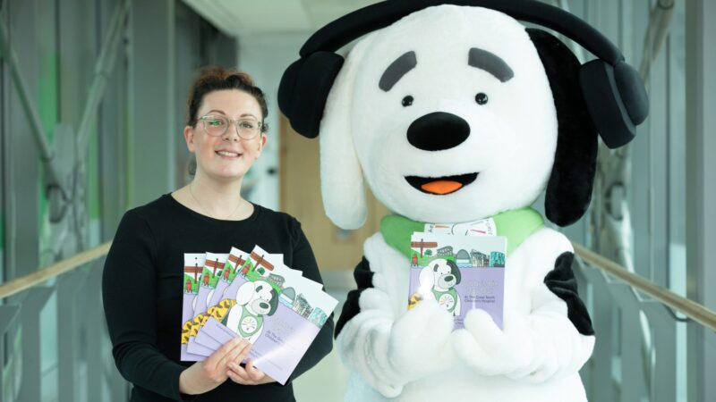 The image shows Bobby the mascot with his book
