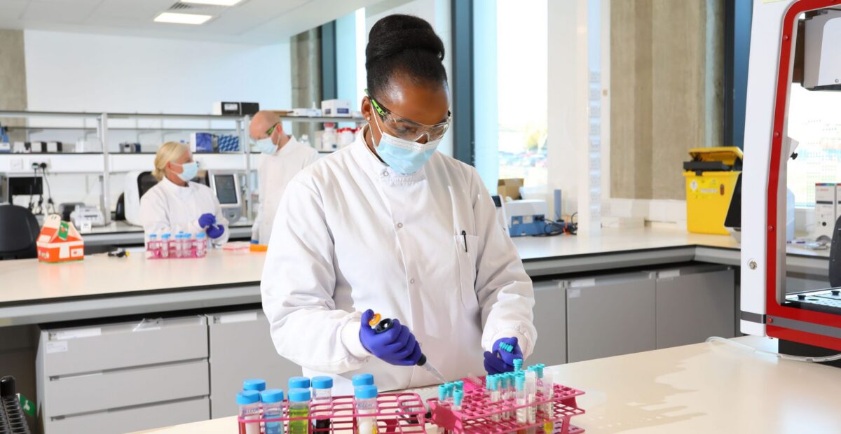 A scientist at a work station performing a scientific tasks at a workstation in the innovation lab.